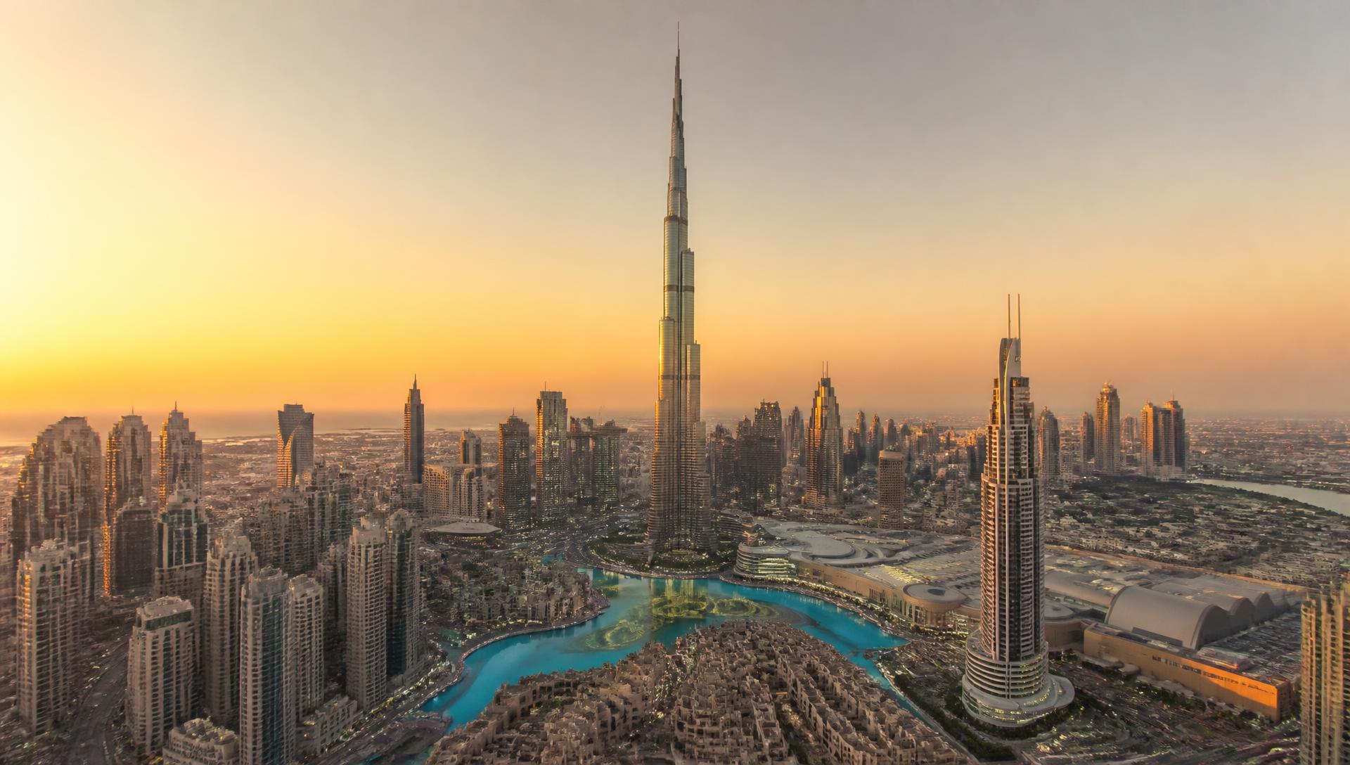 Downtown Dubai skyline at golden hour with Burj Khalifa, built by Emaar Properties, at the centre